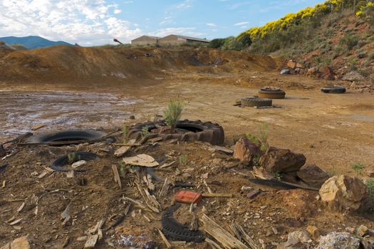 Abandoned car covers in the countryside create pollution.