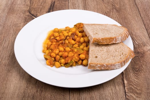 Vegetarian food on a white plate with wooden background