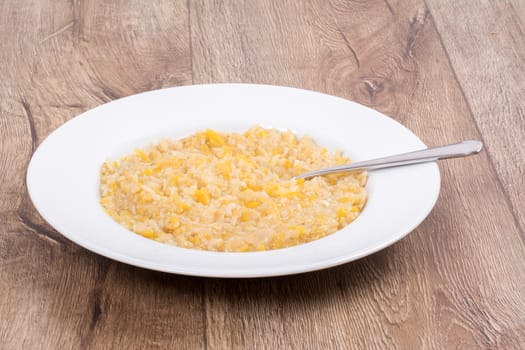 Vegetarian food on a white plate with wooden background