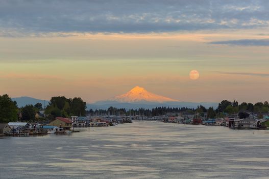 Full moonrise over Mount Hood and floating boat houses along Columbia River