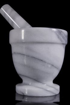 White marble mortar with a pestle on a black background