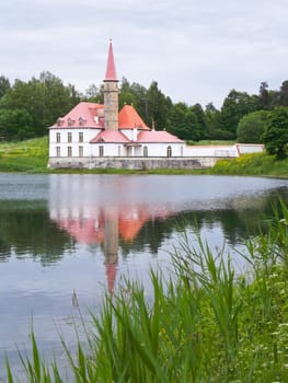 Priory Palace on the shore of a lake surrounded by trees
