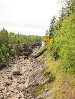 high rocky bank of the river against the backdrop of gray skies