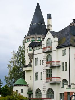 country house with towers against a gray sky