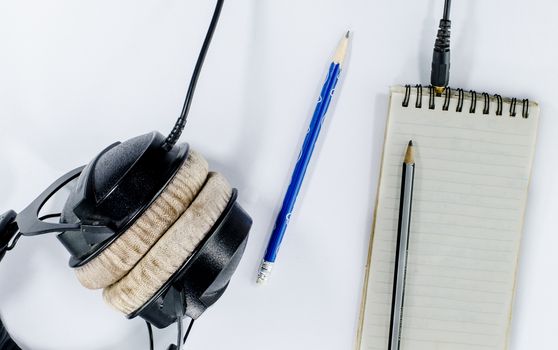 blank notebook in top view with music concept 
whitebackground headphones