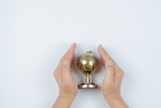 Golden Globe in hand isolated on white background