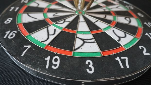 Business concept of darts. The target hanged on the wall.
