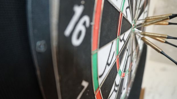 Business concept of darts. The target hanged on the wall.