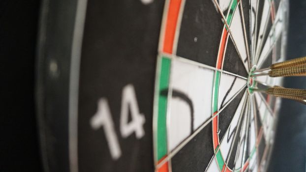 Business concept of darts. The target hanged on the wall.