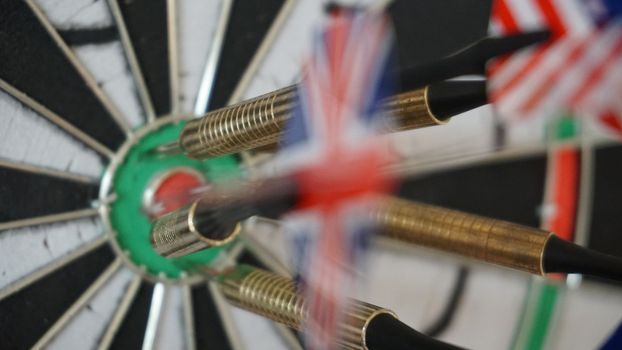 Business concept of darts. The target hanged on the wall.