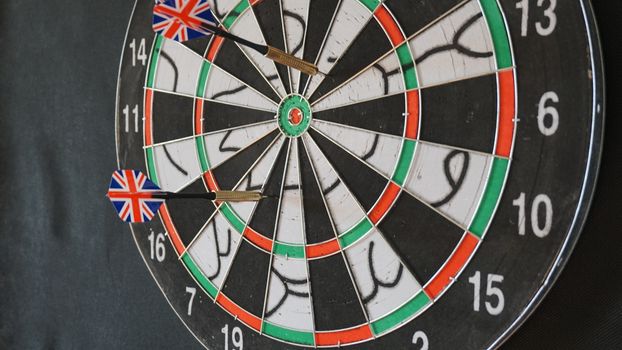 Business concept of darts. The target hanged on the wall.