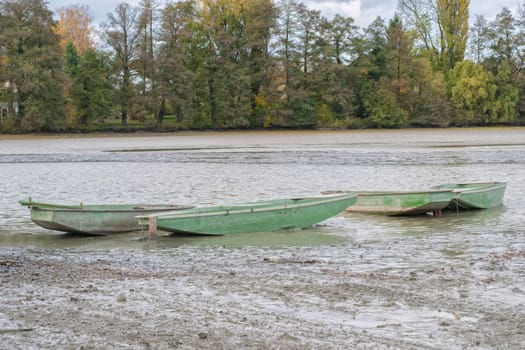 Green boats in a launched pond