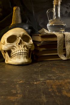 Human skull and ancient books still life