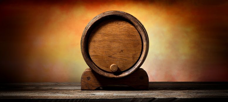 Wooden cask for liquid on old timber table 