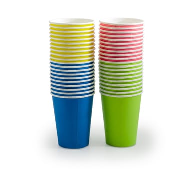 Two piles of the disposable paper cups in red, green, blue and yellow colors on a light background
