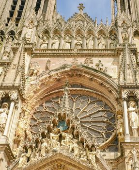 Fragment of the main facade above the central portal of the Cathedral Notre-Dame de Reims, built in the 13th century, France
