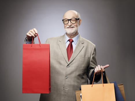 Happy smiling senior man with shopping bags