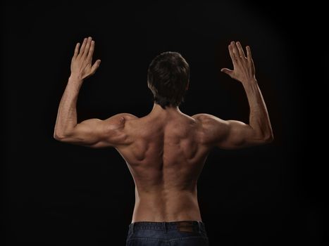 Muscular handsome sexy guy posing, isolated on black background