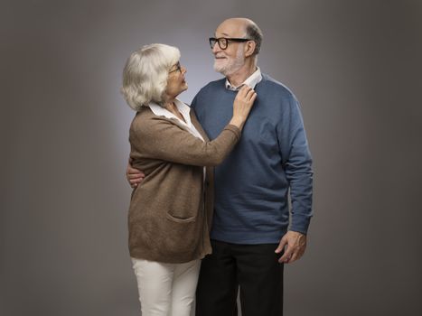 Studio portrait of senior couple on gray background