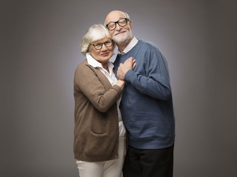 Studio portrait of senior couple on gray background