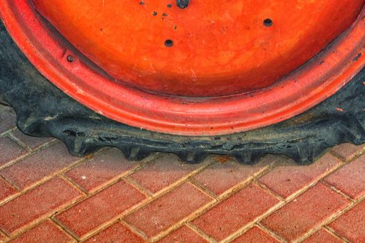 Closeup of a damaged flat tire of a car or tractor on the road.