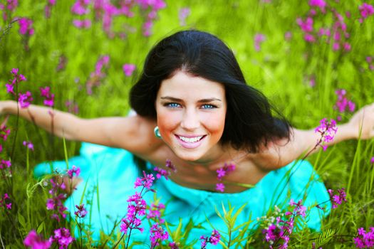 woman sitting on summer flower field