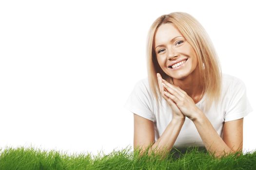 Smiling beautiful woman on grass isolated on white background