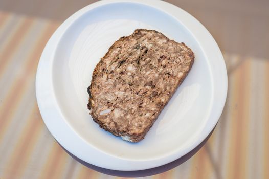 piece rabbit pate in a white plate on the table