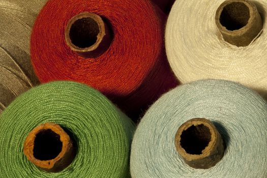 colorful tailor thread bobbin macro shot