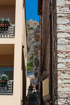 Alley in Taormina with the mountain on background, Sicily, Italy