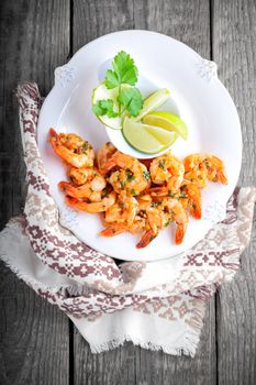 Fried Prawns and lemon served on a white plate