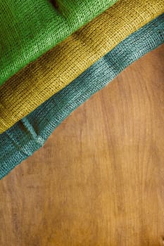 Three-color flag of Gabon on a wooden background.