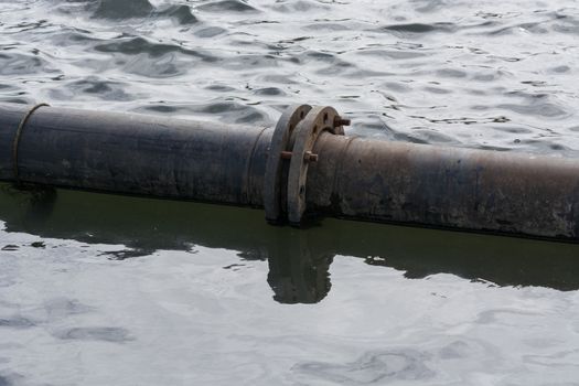 Pipeline, plastic pipes float on the water surface.