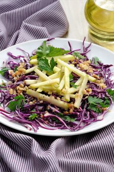 Salad red coleslaw with apple slices and crushed walnut