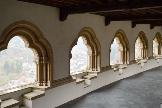 Several arches of the castle of Vianden with a view of the town of Vianden