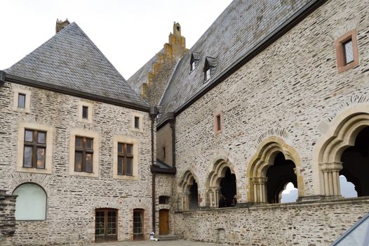 Inner courtyard of the castle of Vianden with arches in stones of france