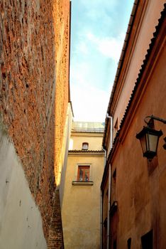 A narrow alley in the old town of Lublin overlooking the sky