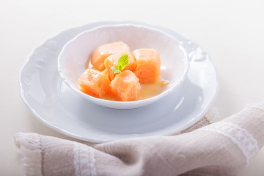 Delicious Apricot sorbet in a white cup served on a table
