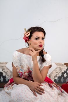 Vintage girl with floral dress relaxing on a park bench.