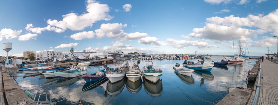 View of several traditional fishing boats on the port of Olhao, Portugal.