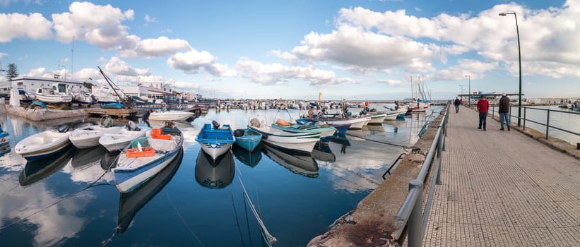 View of several traditional fishing boats on the port of Olhao, Portugal.