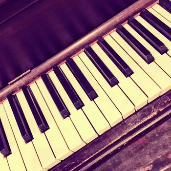 Keyboard of an old piano. Retro style photo.