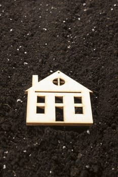 Model of a house in the background of a dug ground