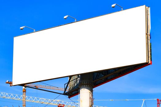 Large blank billboard with blue sky behind it.