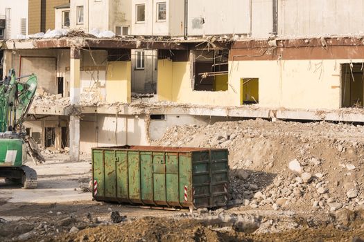 Excavator in front of a demolition site