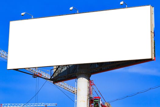 Large blank billboard with blue sky behind it.