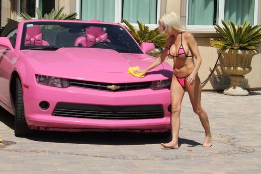 Frenchy Morgan the "Celebrity Big Brother" Star is spotted on a hot day wearing a tiny pink bikini while washing her pink car in Malibu, CA 05-22-17