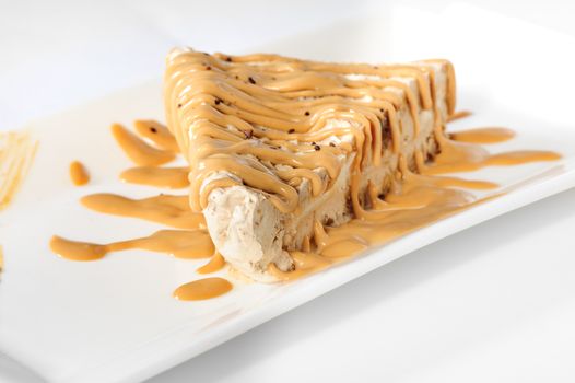 Delicious frozen cheesecake with caramel and sweet condensed milk topping