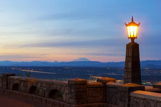 Rocky Butte viewpoint in Portland Oregon with lamp post and Mount St Helens view during sunset
