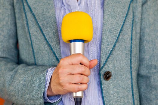 Reporter holding microphone. Media reporting. Journalism.